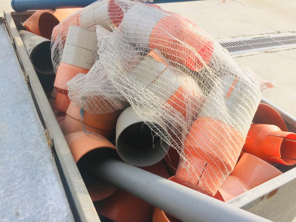 Cassa da muratore con vari tubi in plastica